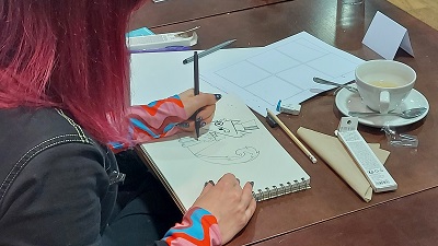 A teacher creating a fox character in a sketchbook with pencil during a CPD workshop in Southampton, organised by Artswork