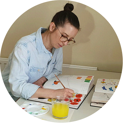 Emily Fellah painting in her sketchbook
